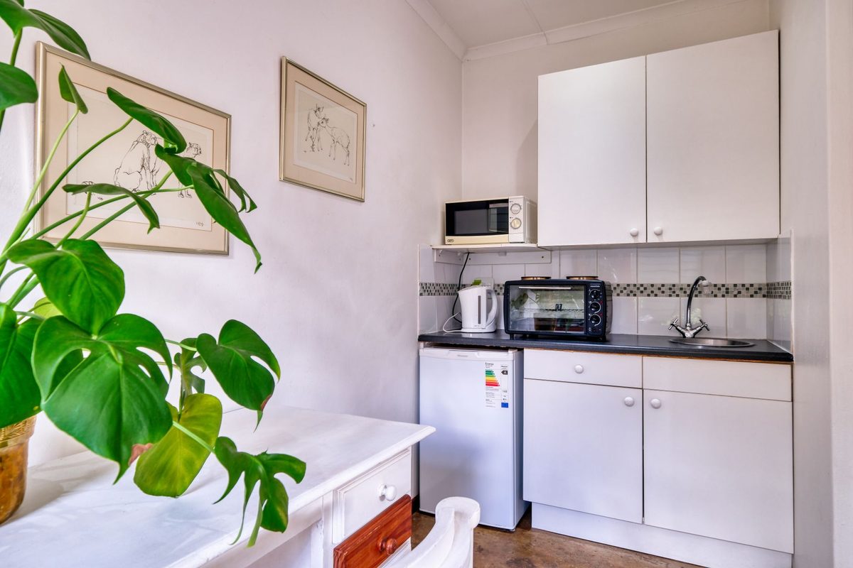 Compact temporary kitchen with microwave, kettle and small fridge
